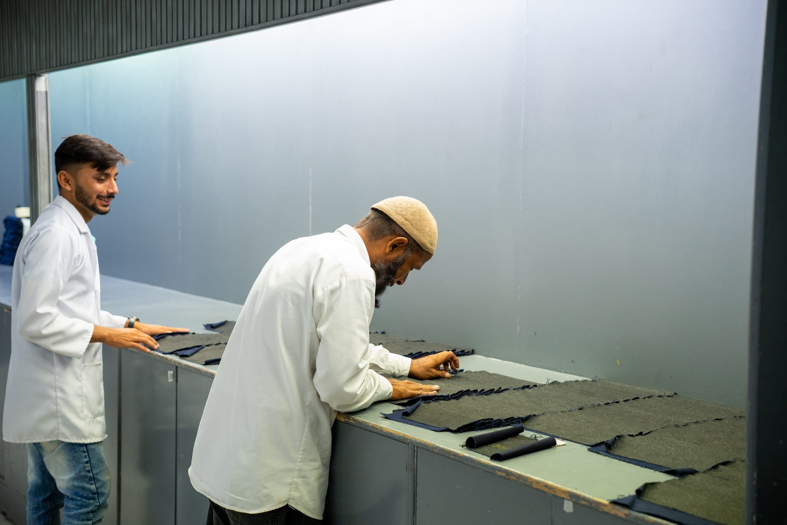 Azgard9 team inspecting denim fabric samples